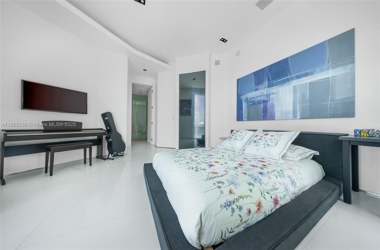 900 Brickell Key Boulevard, Unit 2603 Miami, FL 33131 - Photo 60 of 99 a bedroom with a bed and a flat screen tv