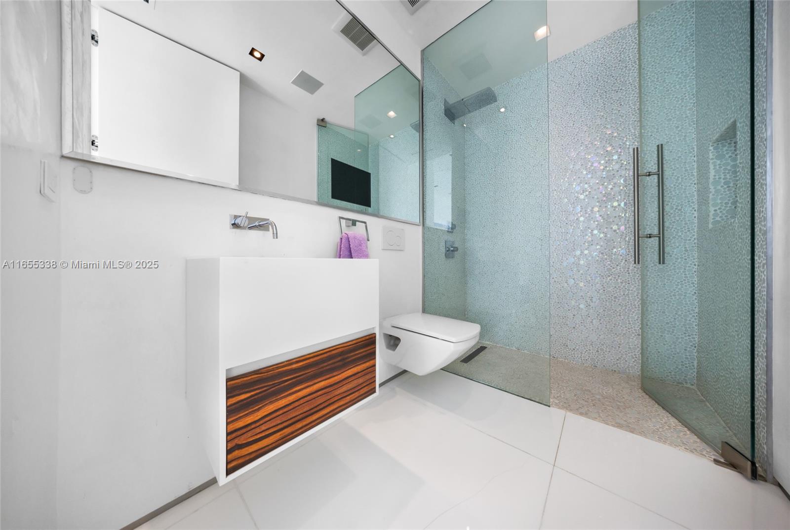 900 Brickell Key Boulevard, Unit 2603 Miami, FL 33131 - Photo 62 of 99 a bathroom with a sink a toilet and shower