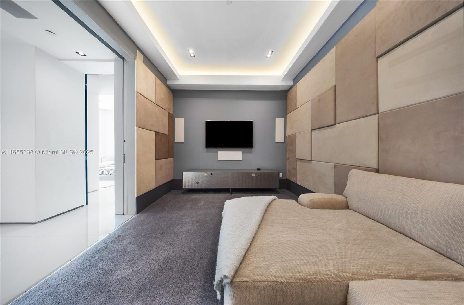 900 Brickell Key Boulevard, Unit 2603 Miami, FL 33131 - Photo 71 of 99 a living room with furniture and a flat screen tv