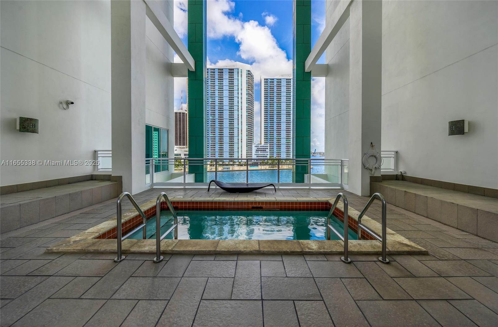 900 Brickell Key Boulevard, Unit 2603 Miami, FL 33131 - Photo 81 of 99 a view of a patio with a table and chairs
