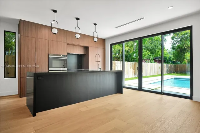a view of a kitchen with a sink and microwave