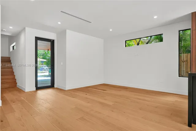 an empty room with windows and closet