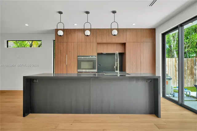 a kitchen with a sink and large window