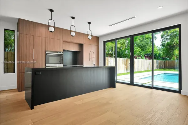 a view of a kitchen with a sink and microwave