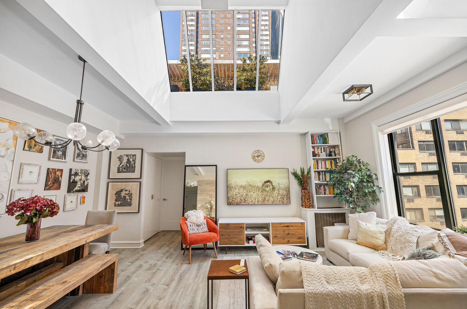 321 West 55th Street, Unit 93 Manhattan, NY 10019 - Photo 2 of 10 a living room with furniture and a large window