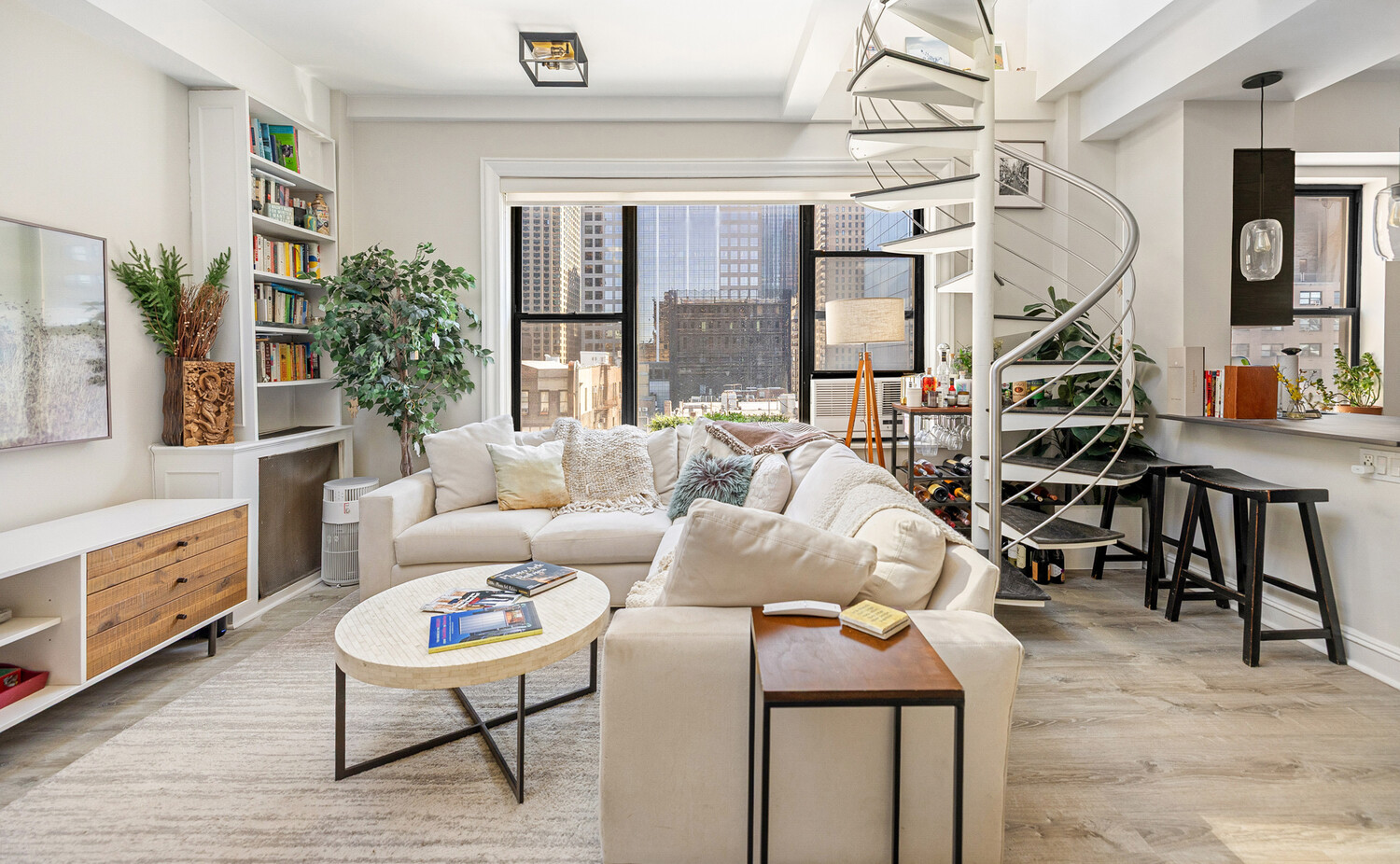 321 West 55th Street, Unit 93 Manhattan, NY 10019 - Photo 3 of 10 a living room with furniture and a window