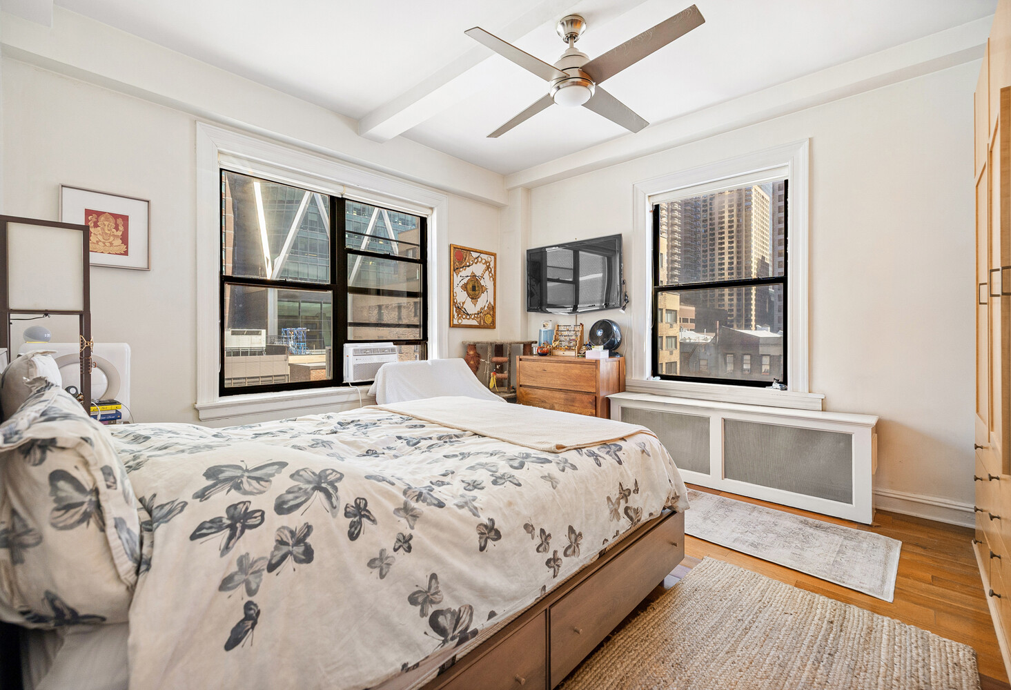 321 West 55th Street, Unit 93 Manhattan, NY 10019 - Photo 4 of 10 a bedroom with a large bed and a window