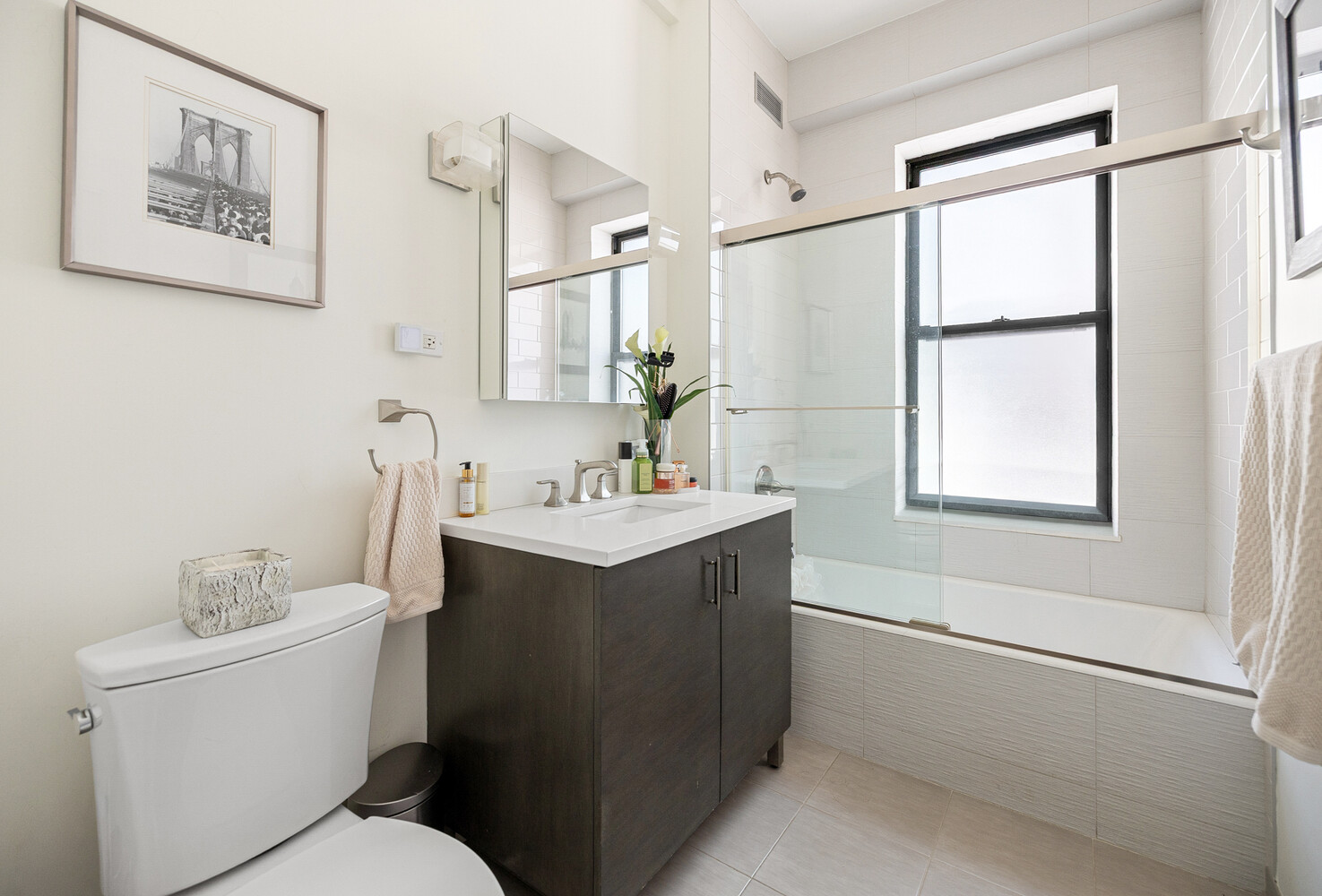 321 West 55th Street, Unit 93 Manhattan, NY 10019 - Photo 7 of 10 a bathroom with a sink toilet and vanity