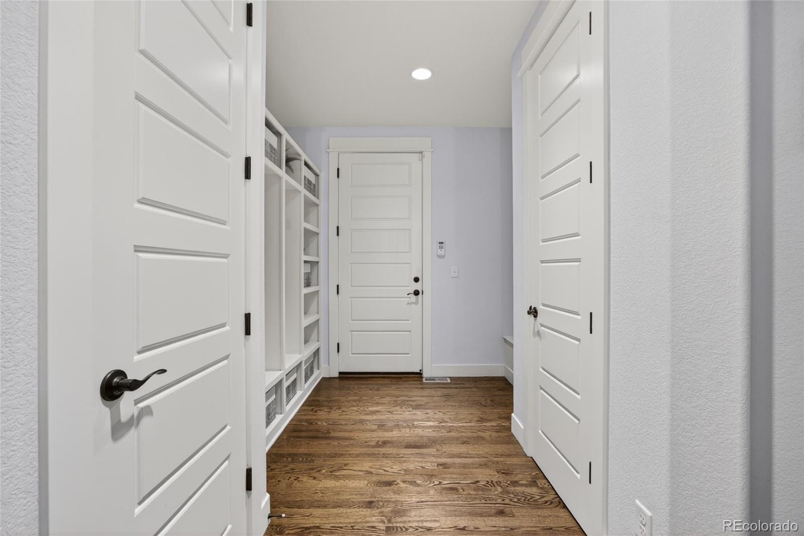 20554 East Shady Ridge Road Parker, CO 80134 - Photo 18 of 49 a view of a hallway with closet and wooden floor