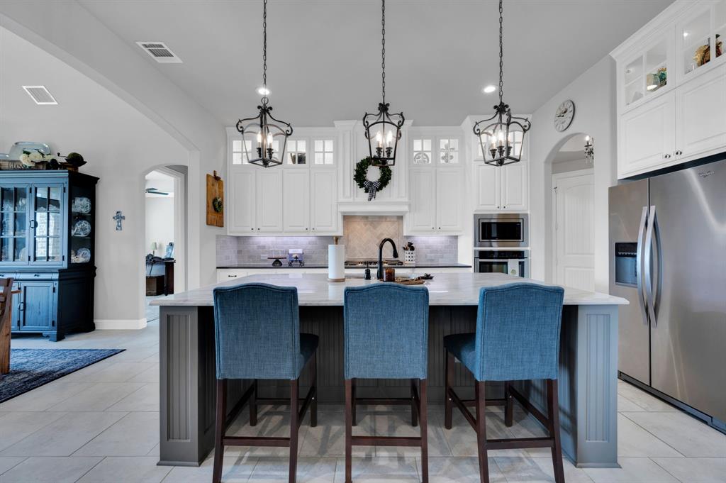 2650 Mc Alpin Road Midlothian, TX 76065 - Photo 10 of 36 View of kitchen with barstools at island.