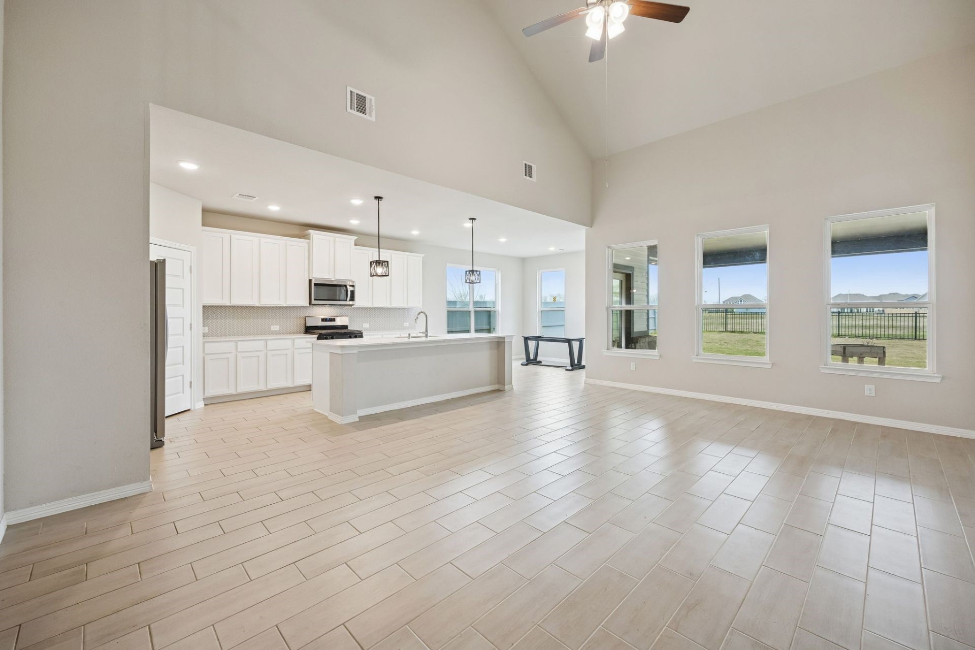 8103 Red Shiner Way Fulshear, TX 77441 - Photo 6 of 29 a view of a kitchen with a sink and microwave