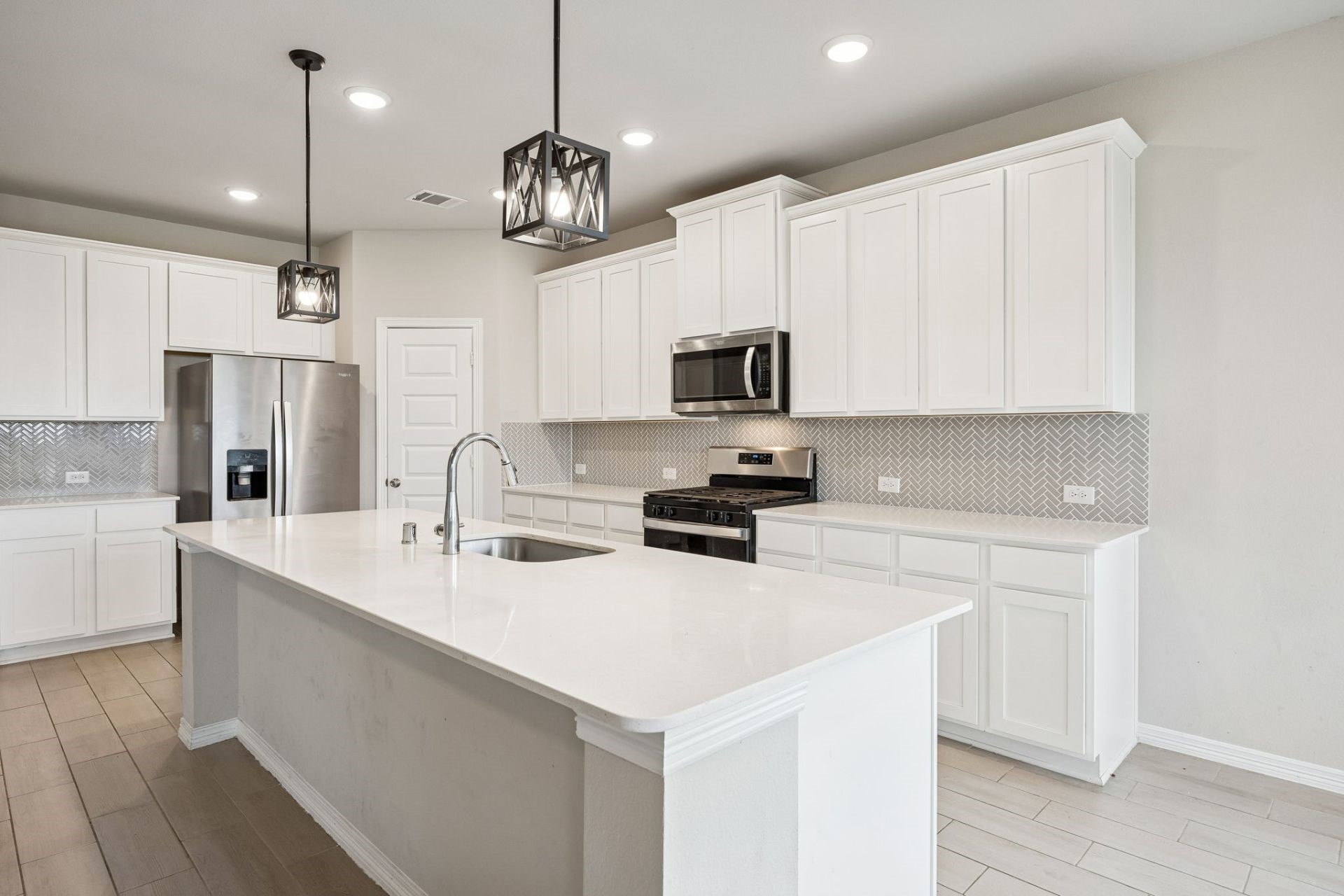 8103 Red Shiner Way Fulshear, TX 77441 - Photo 8 of 29 a kitchen with a refrigerator a sink and microwave