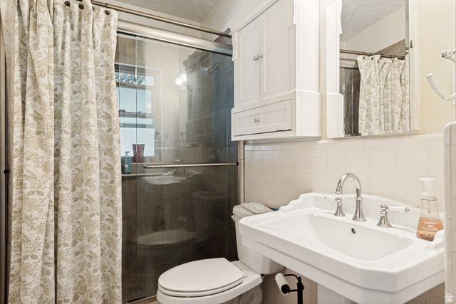 127 West 300 North Springville, UT 84663 - Photo 13 of 24 Bathroom featuring a framed glass walk-in shower, pedestal sink with chrome fixtures, a mirrored medicine cabinet, and a white storage cabinet