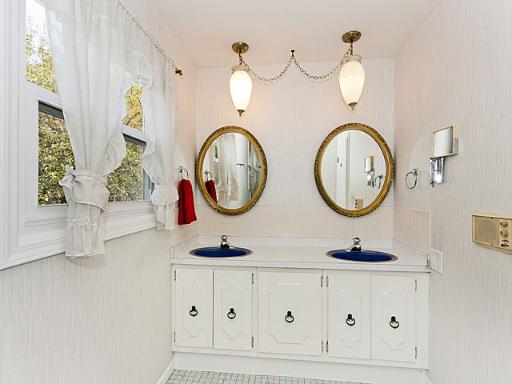 2427 Central Road Glenview, IL 60025 - Photo 12 of 14 a bathroom with a two mirror and a clock on the wall