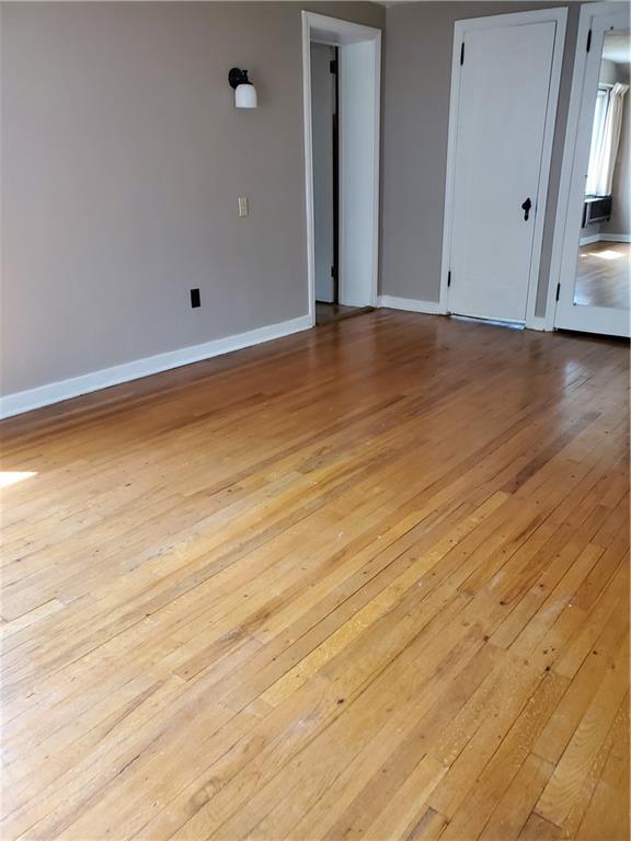 8 Holland Road Pittsburgh, PA 15235 - Photo 20 of 22 a view of an empty room with wooden floor and a window