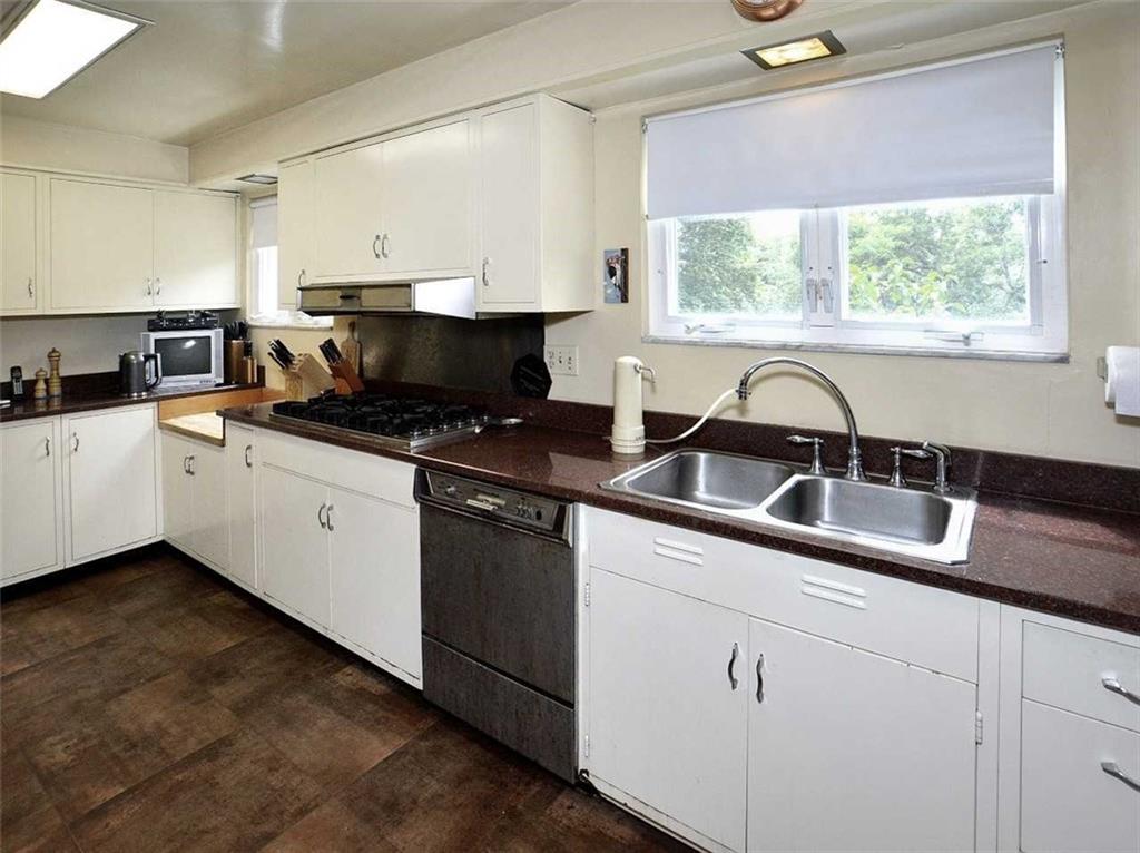8 Holland Road Pittsburgh, PA 15235 - Photo 8 of 22 a kitchen with granite countertop a sink a window and stainless steel appliances