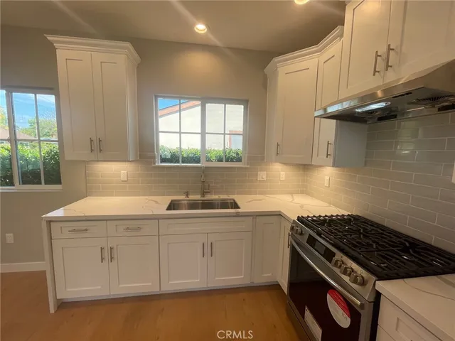 a kitchen that has a sink and a stove