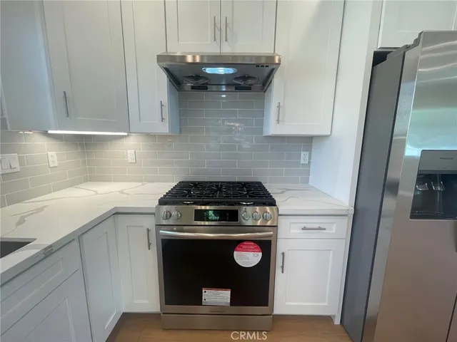 a kitchen with a stove and a refrigerator