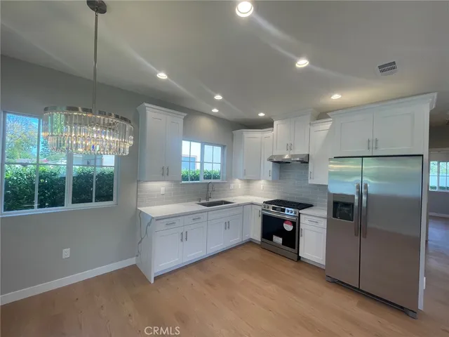 a kitchen with a refrigerator and a sink