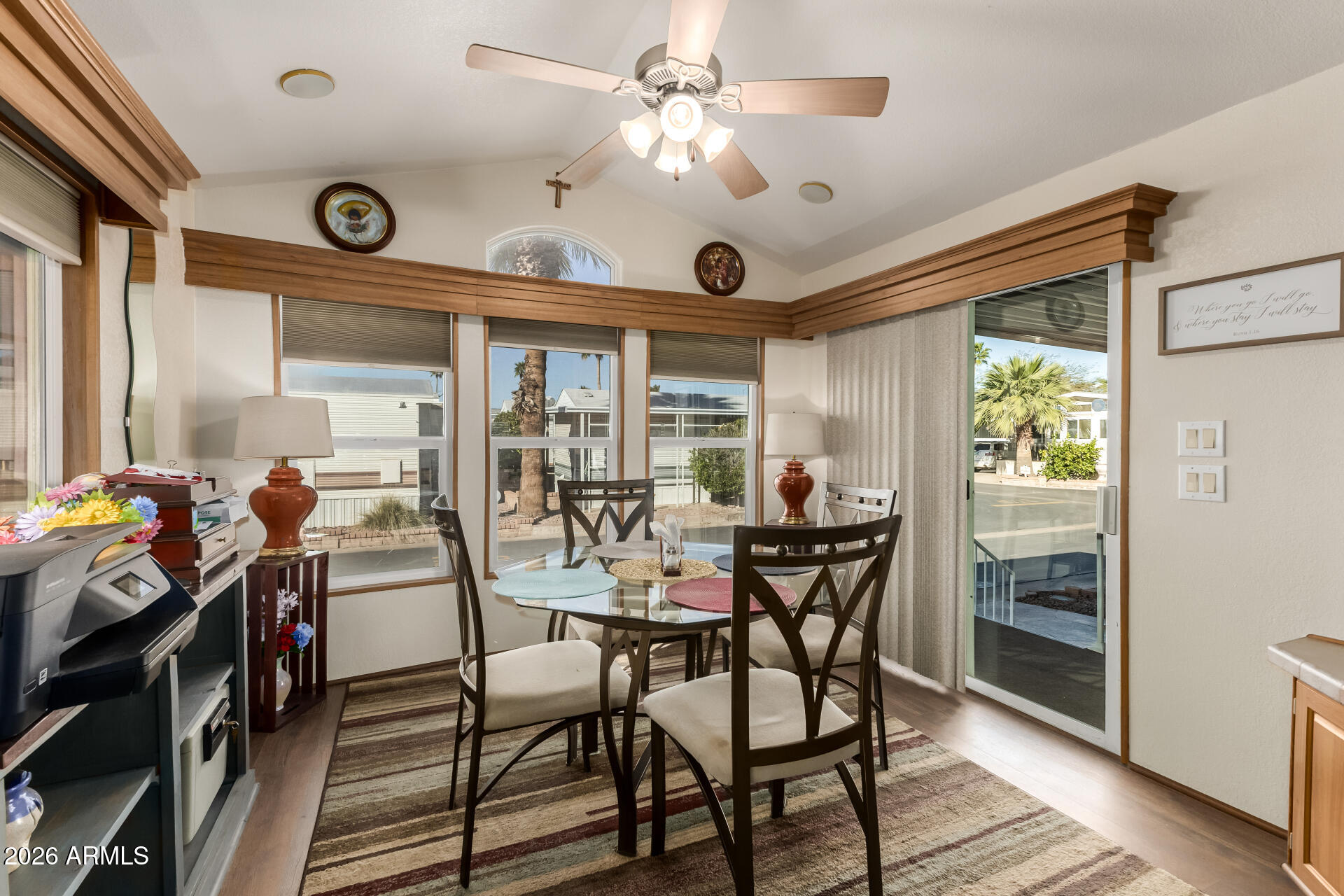 111 South Greenfield Road, Unit 104 Mesa, AZ 85206 - Photo 18 of 74 a view of a dining room with furniture window and wooden floor