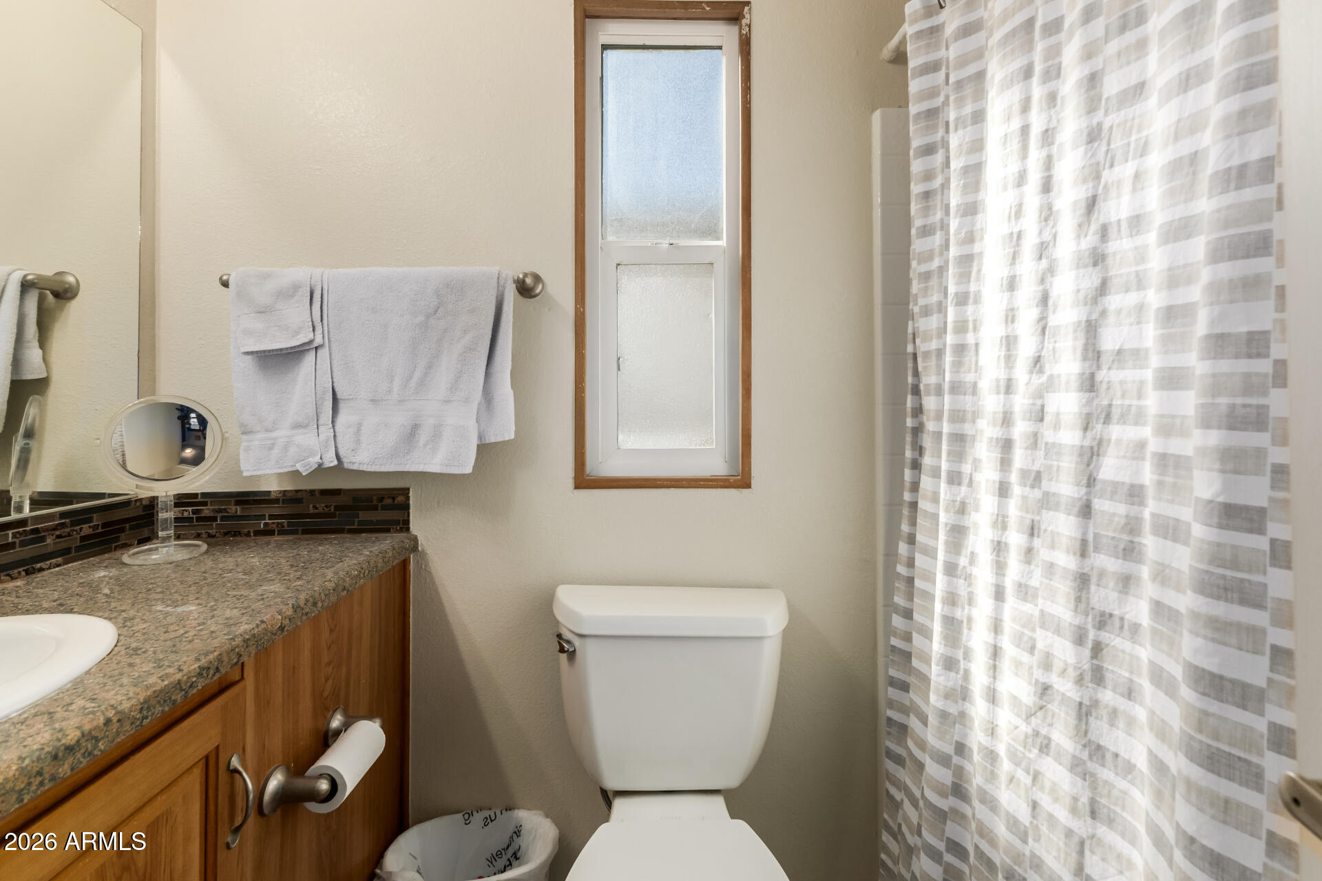 111 South Greenfield Road, Unit 104 Mesa, AZ 85206 - Photo 27 of 74 a bathroom with a granite countertop sink toilet and shower