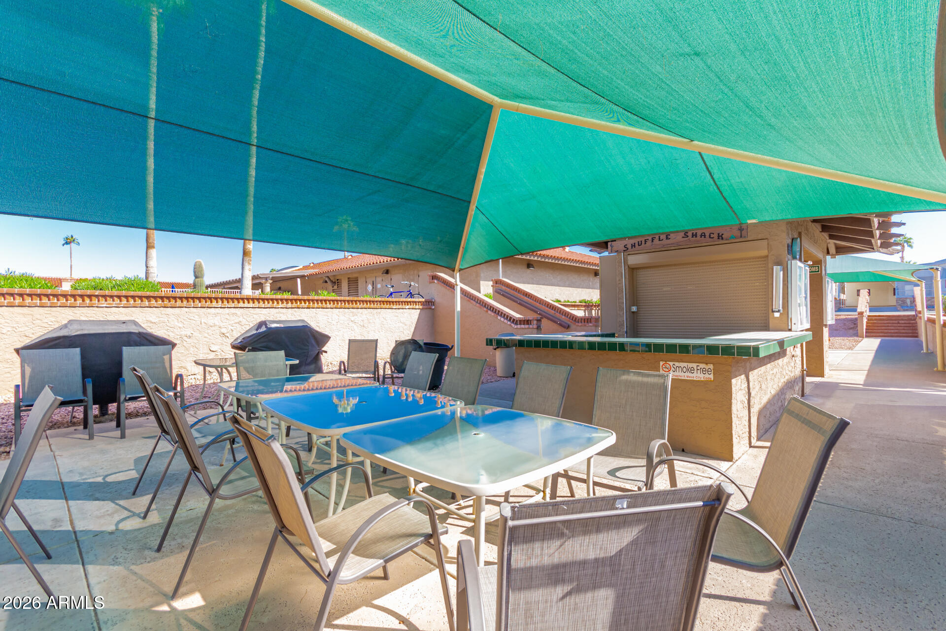 111 South Greenfield Road, Unit 104 Mesa, AZ 85206 - Photo 42 of 74 a table and chairs in the patio
