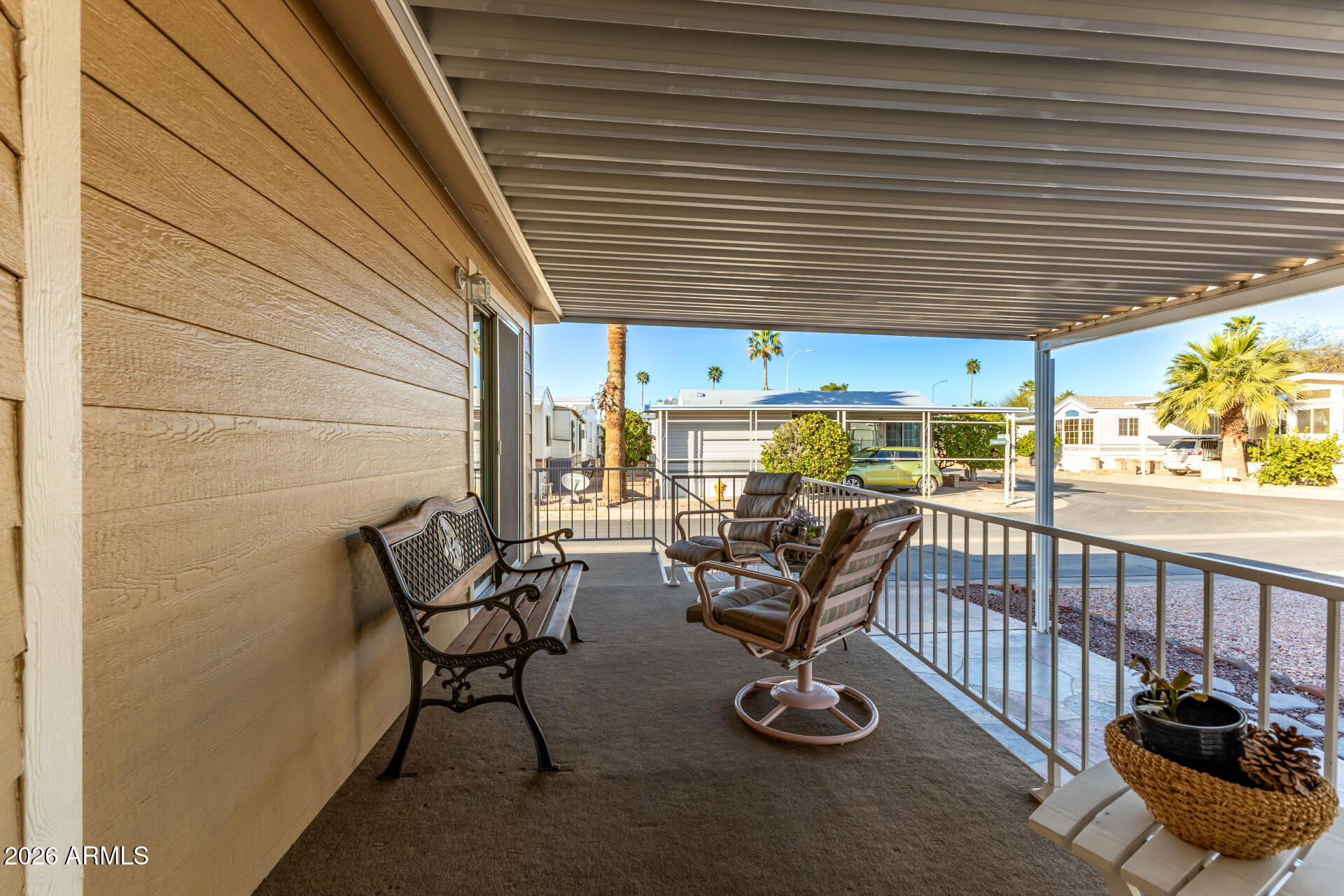 111 South Greenfield Road, Unit 104 Mesa, AZ 85206 - Photo 8 of 74 a view of a porch with furniture and floor to ceiling window