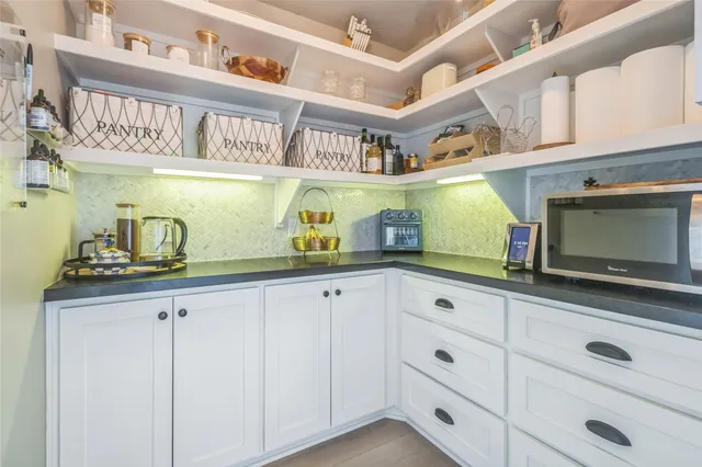 a kitchen with cabinets and window
