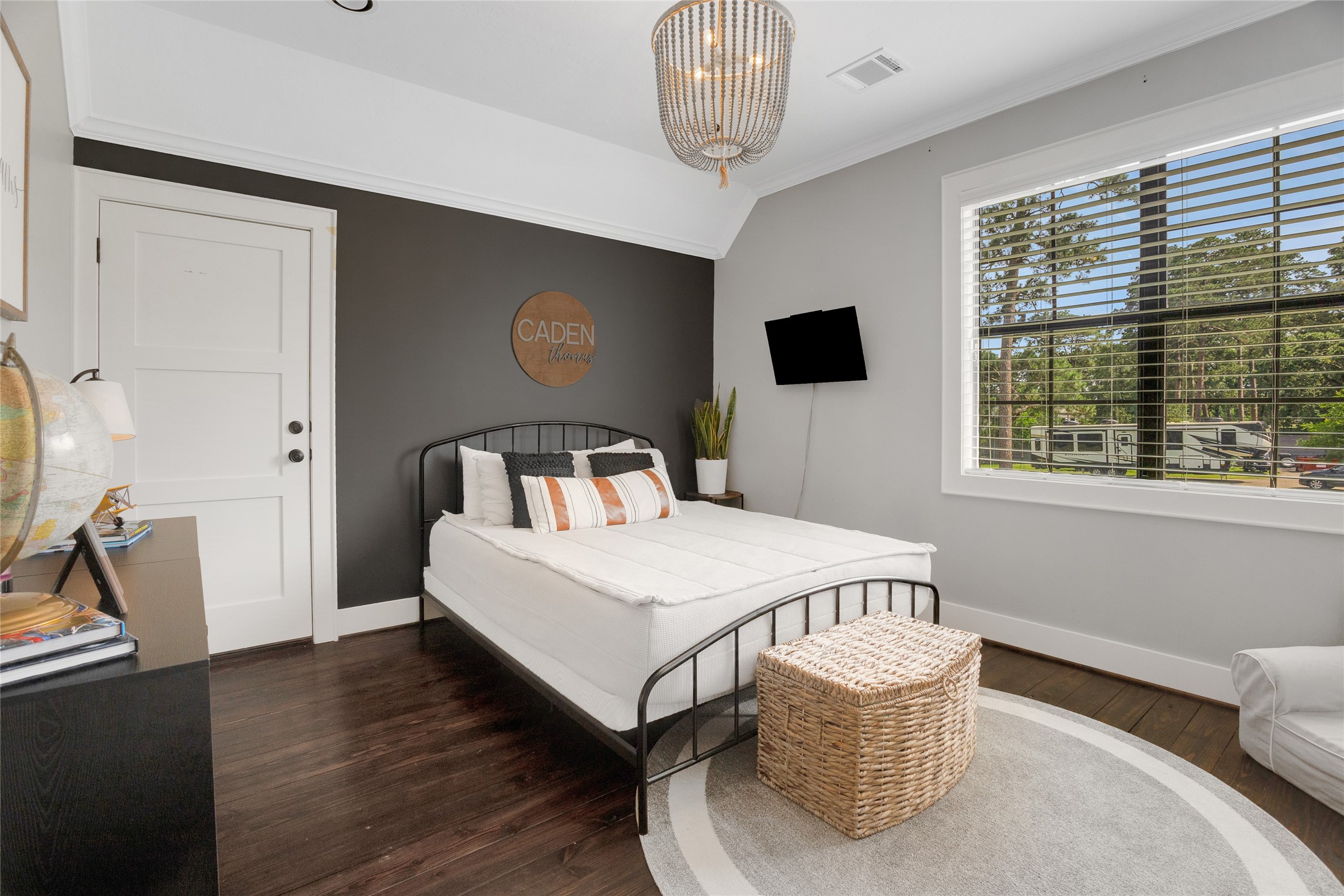 40498 Community Road Magnolia, TX 77354 - Photo 26 of 32 a bedroom with a bed and a flat screen tv