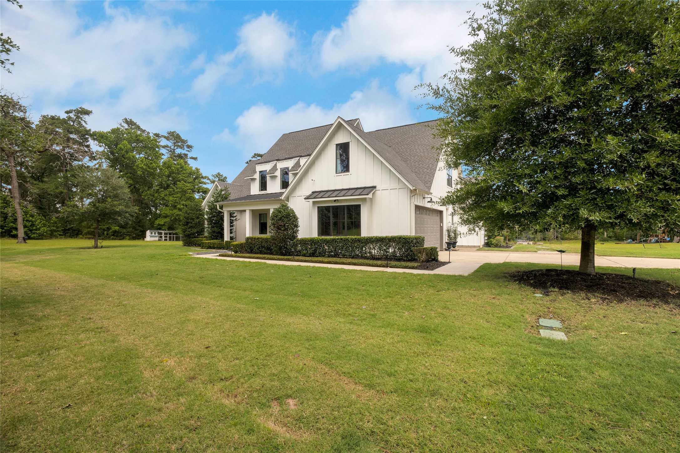 40498 Community Road Magnolia, TX 77354 - Photo 3 of 32 a front view of a house with garden