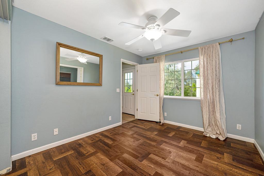 6181 Lambert Lane El Dorado, CA 95623 - Photo 39 of 68 unfurnished room with ceiling fan and dark wood finished floors