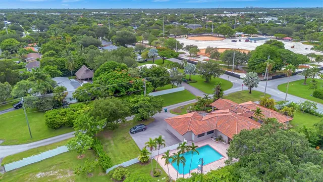 an aerial view of residential houses with outdoor space and street view