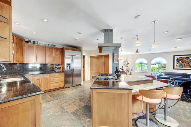 a large kitchen with a table and chairs