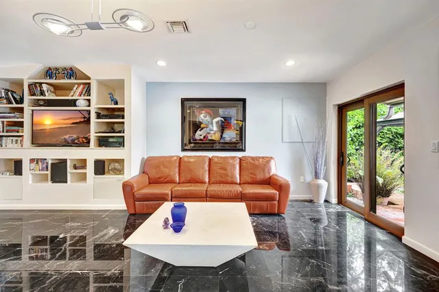 a living room with furniture a rug and a window