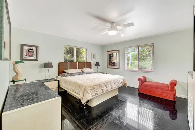 a bedroom with a bed and a painting on the wall