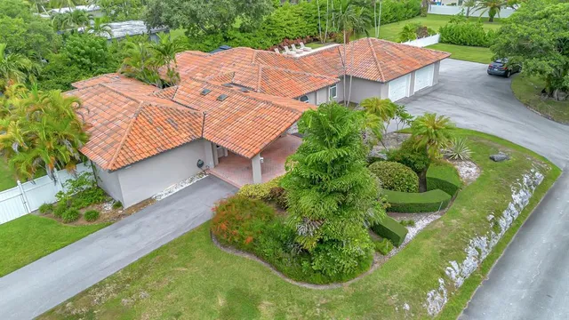 an aerial view of a house with a garden and yard