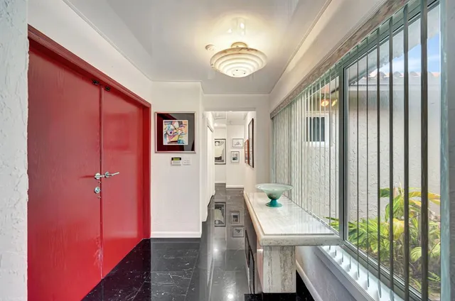 a view of a hallway with furniture and window