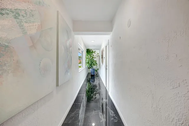 a room with a table chairs and a wooden floor