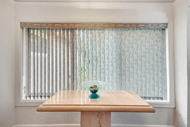 a living room with furniture kitchen view and a large window