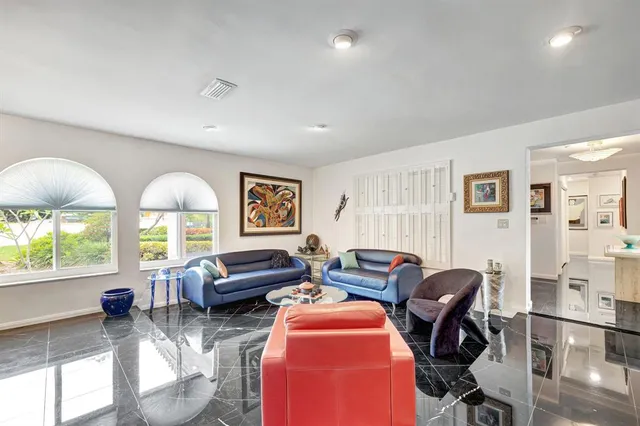 a living room with furniture kitchen view and a table