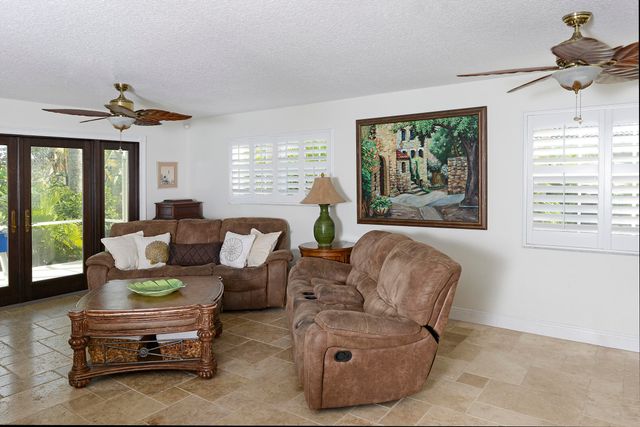 a view of a livingroom with furniture and a large window