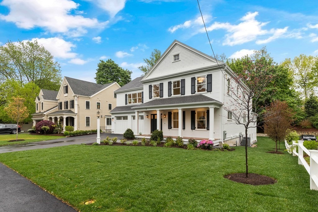 11 Sherman Street Lexington, MA 02420 - Photo 2 of 40 a front view of a house with a yard table and chairs