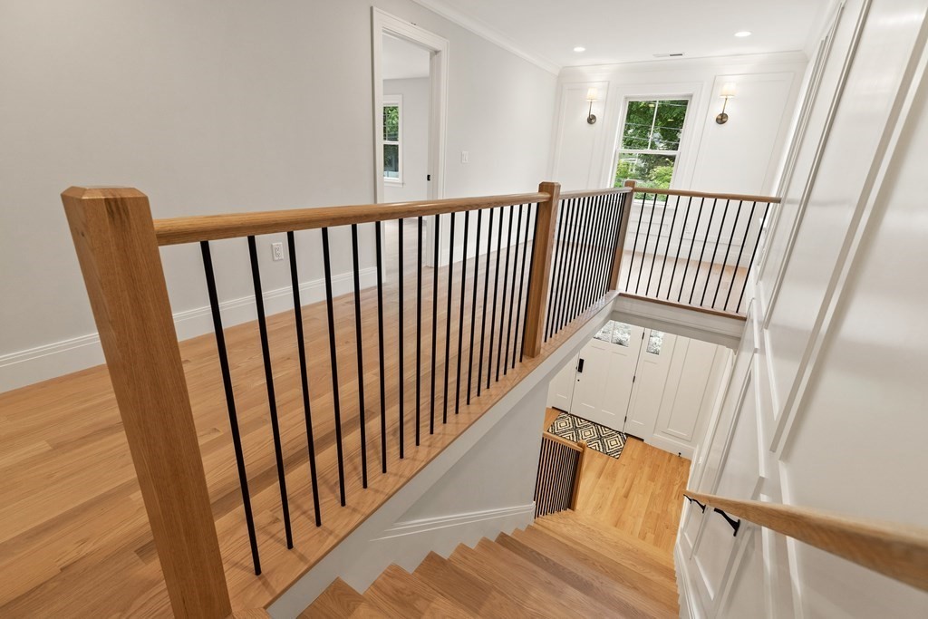 11 Sherman Street Lexington, MA 02420 - Photo 23 of 40 a view of staircase with railing and a wooden floor