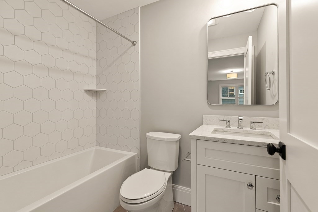 11 Sherman Street Lexington, MA 02420 - Photo 31 of 40 a bathroom with a sink a toilet and shower