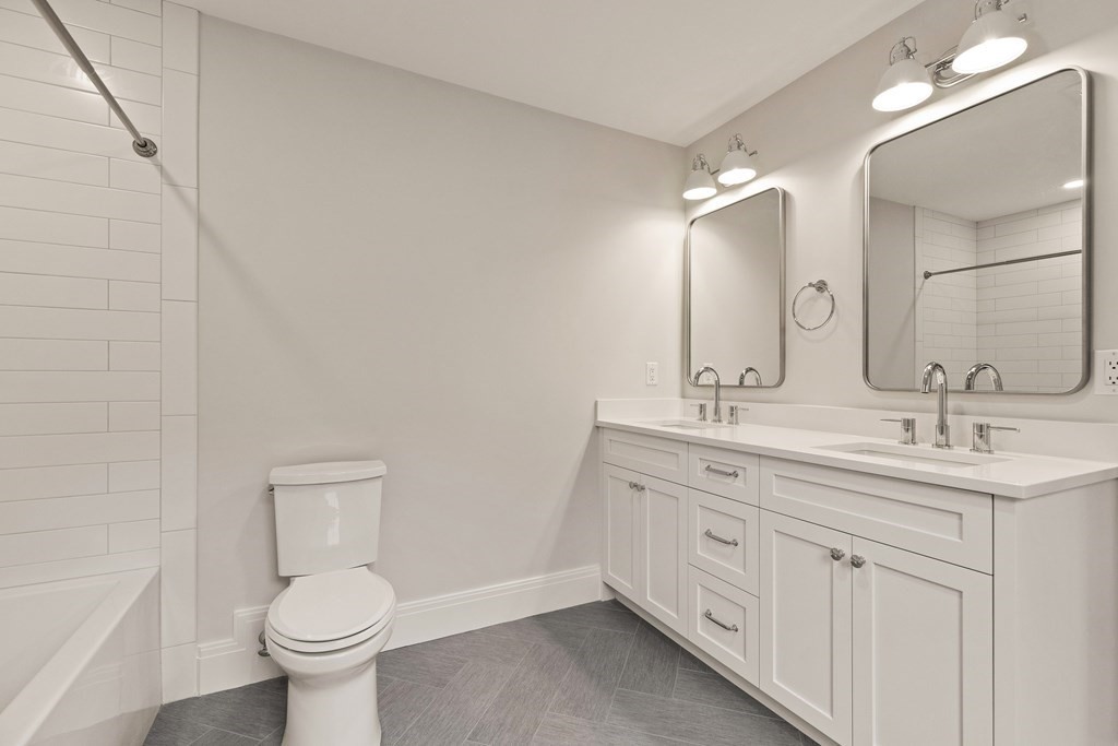 11 Sherman Street Lexington, MA 02420 - Photo 33 of 40 a bathroom with a toilet sink and mirror