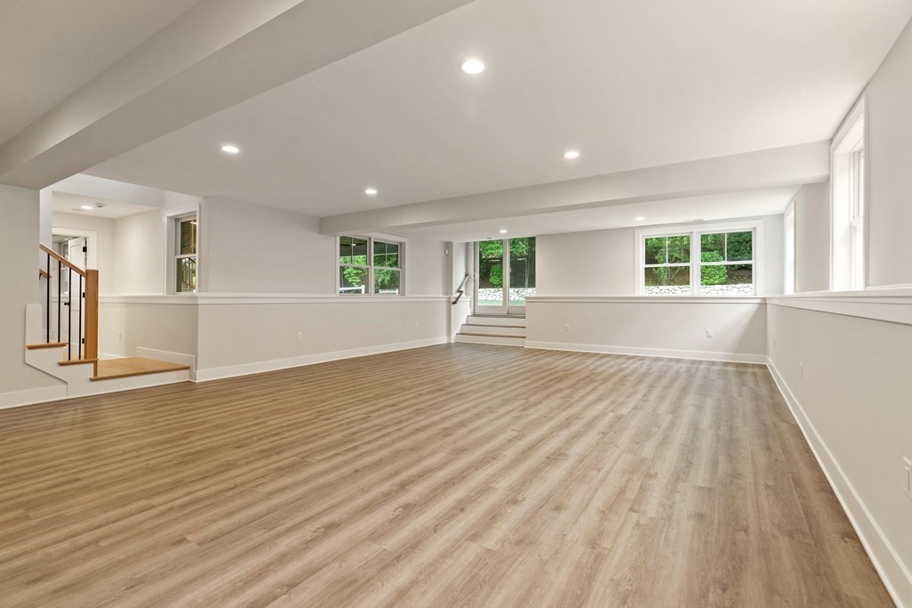 11 Sherman Street Lexington, MA 02420 - Photo 34 of 40 a view of empty room with wooden floor and fan