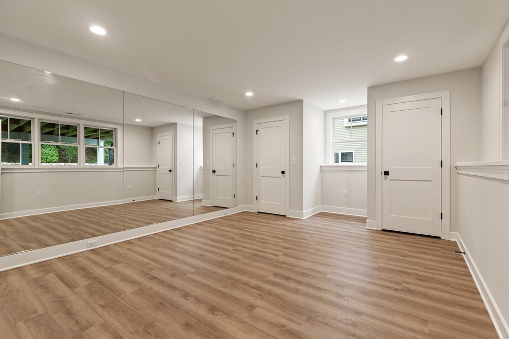 11 Sherman Street Lexington, MA 02420 - Photo 35 of 40 a view of empty room with wooden floor and entryway