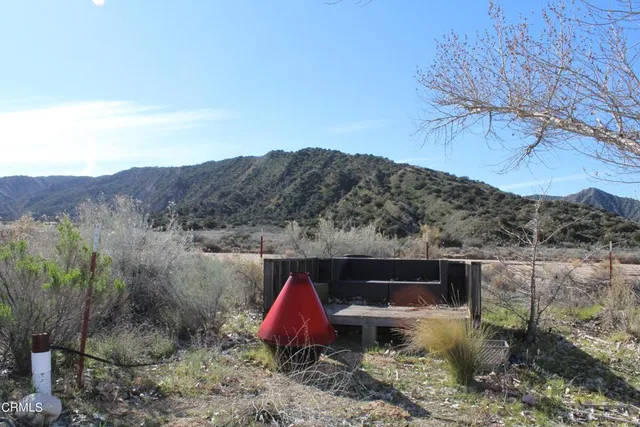 a view of house with a yard and mountain view