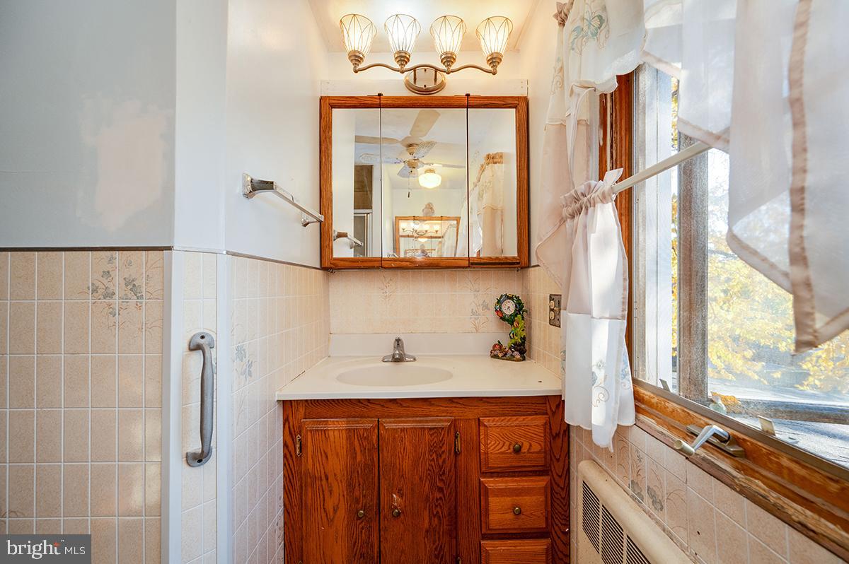 3424 Fremont Street Reading, PA 19605 - Photo 29 of 51 a bathroom with a sink a mirror and a window