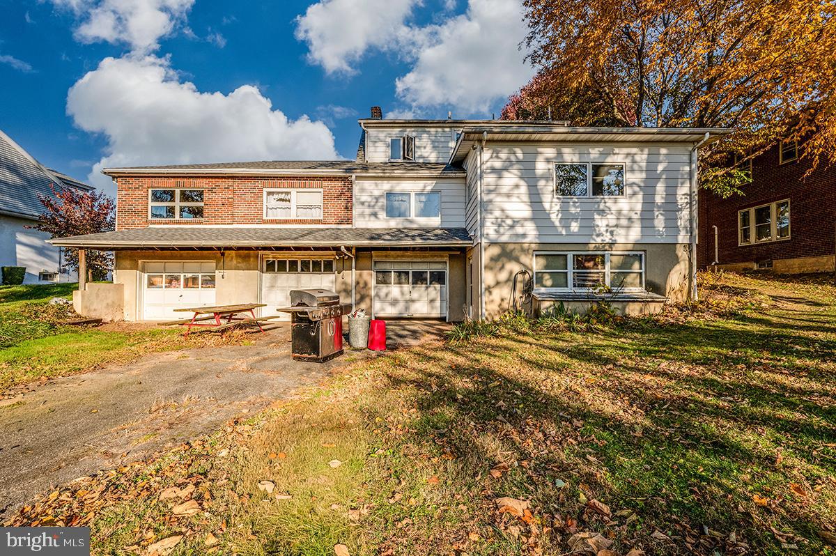 3424 Fremont Street Reading, PA 19605 - Photo 47 of 51 a view of a blue house with large windows and a small yard